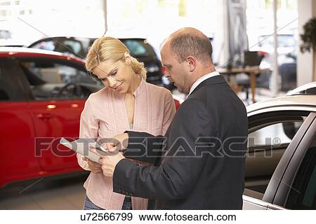 Woman buying new car View Large Photo Image Stock Photo - Woman buying new car. Fotosearch