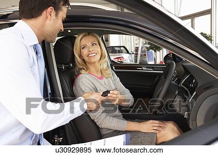 Stock Photography - Woman buying new car. Fotosearch
