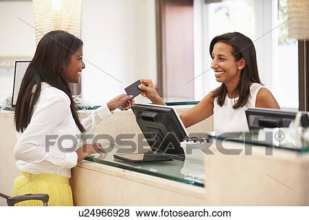Woman Checking In At Hotel Reception View Large Photo Image Stock Photo - Woman Checking In At Hotel Reception. Fotosearch