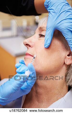 Picture - Woman Having Botox Treatment At Beauty Clinic. Fotosearch