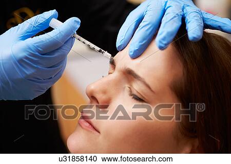Stock Image - Woman Having Botox Treatment At Beauty Clinic. Fotosearch