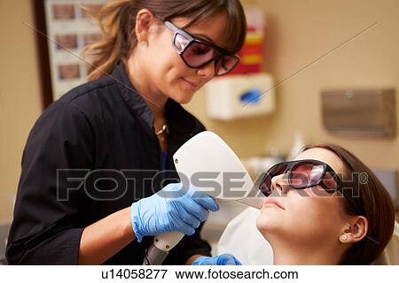 Woman Having Laser Treatment At Beauty Clinic View Large Photo Image Stock Photo - Woman Having Laser Treatment At Beauty Clinic. Fotosearch