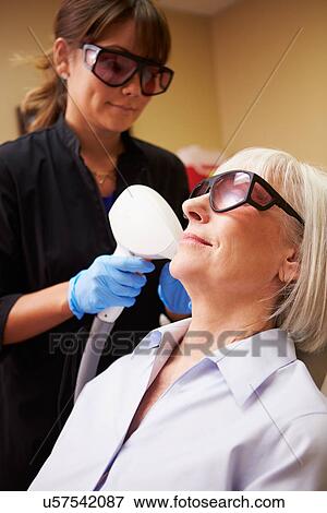 Woman Having Laser Treatment At Beauty Clinic View Large Photo Image Stock Photo - Woman Having Laser Treatment At Beauty Clinic. Fotosearch