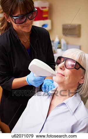 Woman Having Laser Treatment At Beauty Clinic View Large Photo Image Stock Photo - Woman Having Laser Treatment At Beauty Clinic. Fotosearch