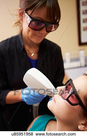Woman Having Laser Treatment At Beauty Clinic View Large Photo Image Stock Photo - Woman Having Laser Treatment At Beauty Clinic. Fotosearch