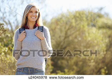 Woman Hiking In Countryside Wearing Backpack View Large Photo Image Stock Photo - Woman Hiking In Countryside Wearing Backpack. Fotosearch