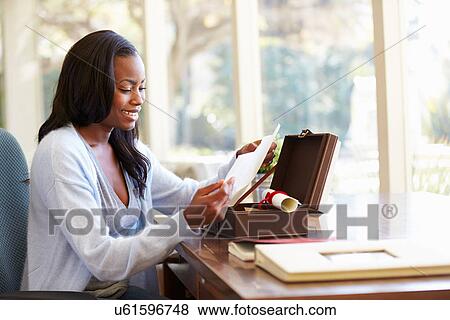 Woman Looking At Letter In Keepsake Box On Desk View Large Photo Image Stock Photo - Woman Looking At Letter In Keepsake Box On Desk. Fotosearch