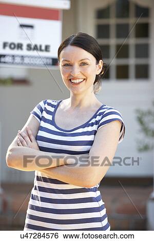 Woman moving into new home View Large Photo Image Stock Photograph - Woman moving into new home. Fotosearch