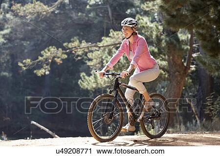Woman on country bike ride View Large Photo Image Stock Image - Woman on country bike ride. Fotosearch