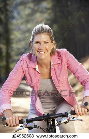Woman on country bike ride View Large Photo Image Stock Photo - Woman on country bike ride. Fotosearch