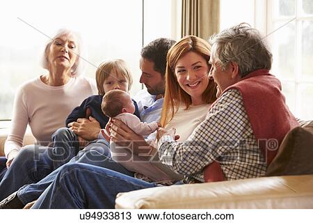 Stock Image - Woman On Roof Terrace Using Digital Tablet. Fotosearch