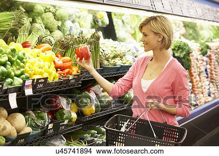 Woman shopping in supermarket View Large Photo Image Picture - Woman shopping in supermarket. Fotosearch