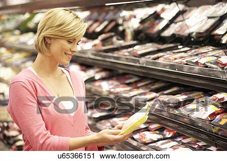 Woman shopping in supermarket View Large Photo Image Stock Image - Woman shopping in supermarket. Fotosearch