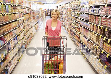 Woman shopping in supermarket View Large Photo Image Stock Image - Woman shopping in supermarket. Fotosearch