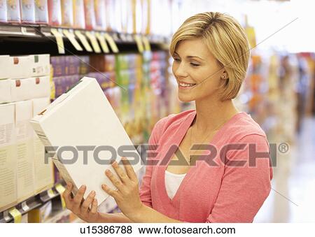Stock Photo - Woman shopping in supermarket. Fotosearch
