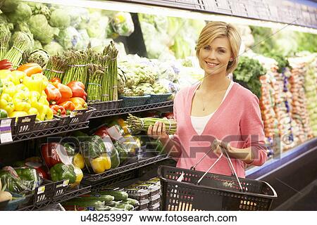 Woman shopping in supermarket View Large Photo Image Stock Photo - Woman shopping in supermarket. Fotosearch