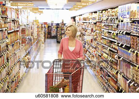 Woman shopping in supermarket View Large Photo Image Stock Photo - Woman shopping in supermarket. Fotosearch