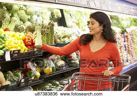 Stock Photograph - Woman shopping in supermarket. Fotosearch