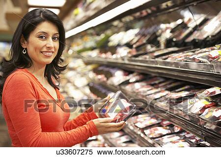 Woman shopping in supermarket View Large Photo Image Stock Photography - Woman shopping in supermarket. Fotosearch