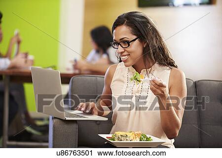 Woman Sitting On Sofa And Eating Lunch In Design Studio View Large Photo Image Stock Image - Woman Sitting On Sofa And Eating Lunch In Design Studio . Fotosearch