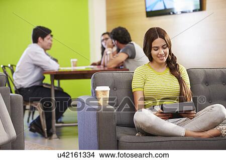 Picture - Woman Sitting On Sofa And Working In Design Studio . Fotosearch