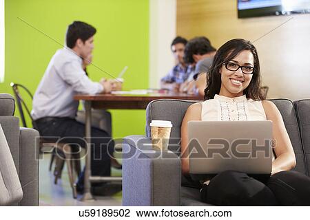 Woman Sitting On Sofa And Working In Design Studio View Large Photo Image Stock Image - Woman Sitting On Sofa And Working In Design Studio . Fotosearch