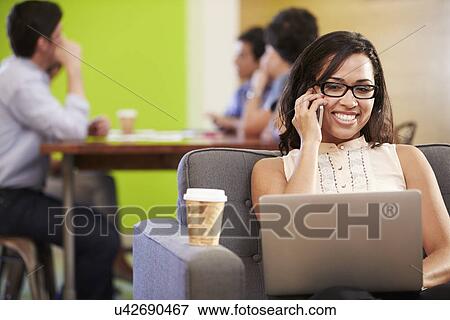 Woman Sitting On Sofa And Working In Design Studio View Large Photo Image Stock Photo - Woman Sitting On Sofa And Working In Design Studio . Fotosearch