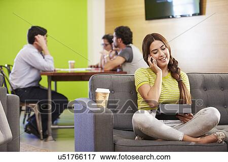 Woman Sitting On Sofa And Working In Design Studio View Large Photo Image Stock Photo - Woman Sitting On Sofa And Working In Design Studio . Fotosearch