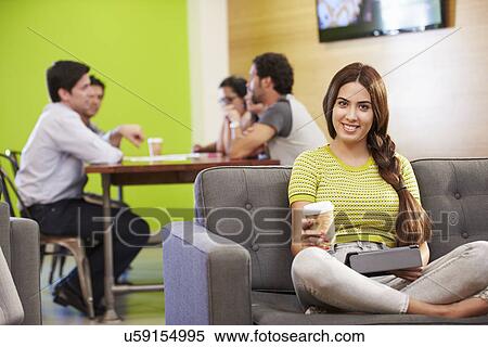 Woman Sitting On Sofa And Working In Design Studio View Large Photo Image Stock Photography - Woman Sitting On Sofa And Working In Design Studio . Fotosearch