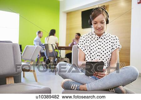 Stock Image - Woman Taking A Break Working In Design Studio . Fotosearch
