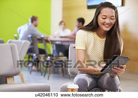 Stock Image - Woman Taking A Break Working In Design Studio . Fotosearch