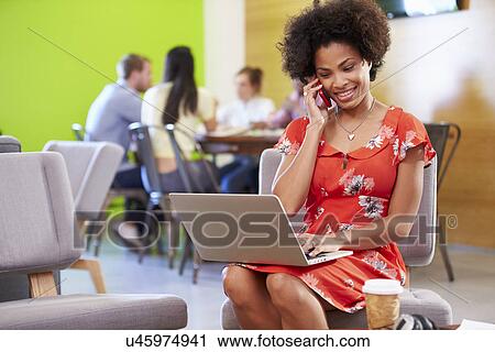 Stock Image - Woman Taking A Break Working In Design Studio . Fotosearch