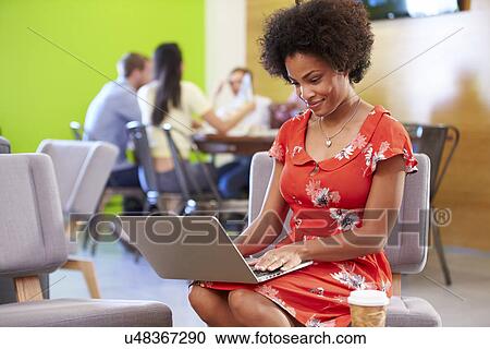 Stock Image - Woman Taking A Break Working In Design Studio . Fotosearch