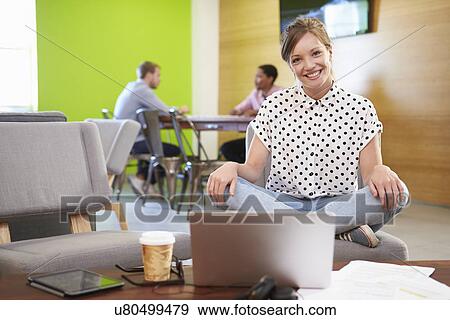 Stock Photo - Woman Taking A Break Working In Design Studio . Fotosearch