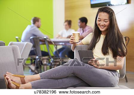 Stock Photograph - Woman Taking A Break Working In Design Studio . Fotosearch