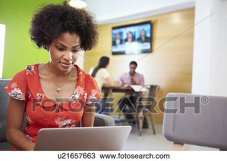 Woman Taking A Break Working On Sofa In Design Studio View Large Photo Image Stock Image - Woman Taking A Break Working On Sofa In Design Studio . Fotosearch