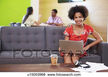 Woman Taking A Break Working On Sofa In Design Studio View Large Photo Image Stock Photo - Woman Taking A Break Working On Sofa In Design Studio . Fotosearch