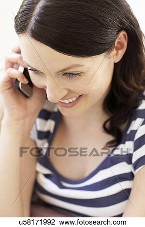 Stock Image - Woman talking on phone. Fotosearch