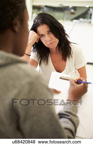 Woman Talking To Counsellor Who Takes Notes View Large Photo Image Stock Photo - Woman Talking To Counsellor Who Takes Notes. Fotosearch