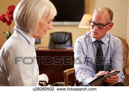 Woman Talking To Male Counsellor Using Digital Tablet View Large Photo Image Stock Image - Woman Talking To Male Counsellor Using Digital Tablet. Fotosearch