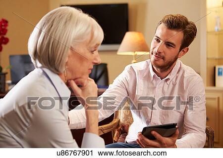 Woman Talking To Male Counsellor Using Digital Tablet View Large Photo Image Stock Image - Woman Talking To Male Counsellor Using Digital Tablet. Fotosearch