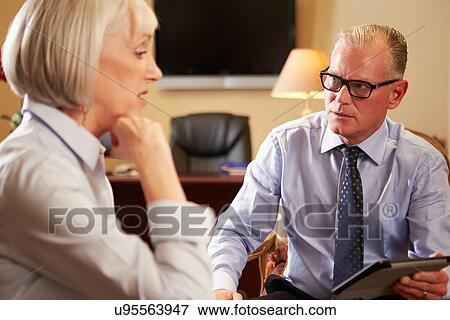 Woman Talking To Male Counsellor Using Digital Tablet View Large Photo Image Stock Photo - Woman Talking To Male Counsellor Using Digital Tablet. Fotosearch