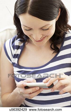 Woman texting on phone View Large Photo Image Stock Photo - Woman texting on phone. Fotosearch