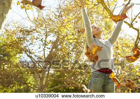 Woman Throwing Autumn Leaves In The Air View Large Photo Image Picture - Woman Throwing Autumn Leaves In The Air. Fotosearch