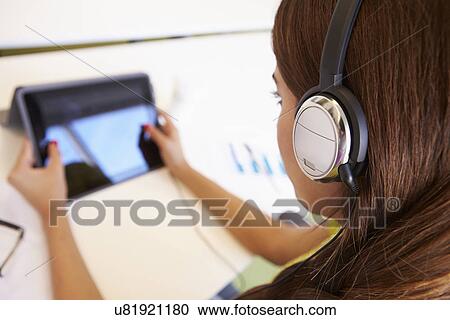 Woman Using Digital Tablet And Headphones In Design Studio View Large Photo Image Stock Image - Woman Using Digital Tablet And Headphones In Design Studio. Fotosearch