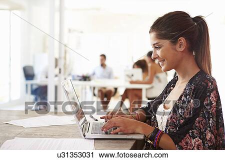 Woman Using Laptop In Modern Office Of Start Up Business View Large Photo Image Stock Image - Woman Using Laptop In Modern Office Of Start Up Business. Fotosearch