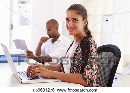 Woman Using Laptop In Modern Office Of Start Up Business View Large Photo Image Stock Photograph - Woman Using Laptop In Modern Office Of Start Up Business. Fotosearch
