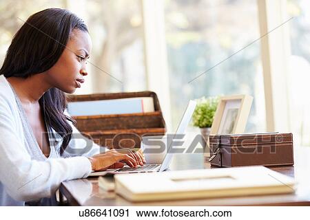 Woman Using Laptop On Desk At Home View Large Photo Image Stock Image - Woman Using Laptop On Desk At Home. Fotosearch