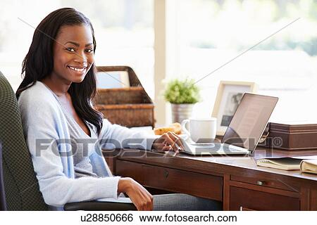 Woman Using Laptop On Desk At Home View Large Photo Image Stock Photograph - Woman Using Laptop On Desk At Home. Fotosearch
