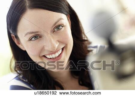 Stock Image - Woman using skype. Fotosearch
